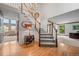 Staircase in entryway featuring hardwood floors, a chandelier, and decorative wainscoting at 4161 W Lake Cir, Littleton, CO 80123