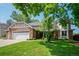 Charming two-story home featuring a well-manicured lawn and a classic brick and siding exterior at 4161 W Lake Cir, Littleton, CO 80123