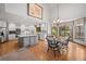 Open concept kitchen featuring a large island, stainless appliances, and an adjacent dining area with great natural light at 4161 W Lake Cir, Littleton, CO 80123