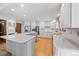 Spacious kitchen featuring white cabinets, stainless steel appliances, and a large center island at 4161 W Lake Cir, Littleton, CO 80123