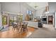Bright living space with cathedral ceiling with a fireplace, entertainment center and multiple windows at 4161 W Lake Cir, Littleton, CO 80123