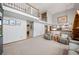 Spacious living room with neutral paint and carpet, flowing into the kitchen at 4161 W Lake Cir, Littleton, CO 80123