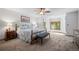Spacious main bedroom boasts a wooden bed frame, ceiling fan, and bright bay windows at 4161 W Lake Cir, Littleton, CO 80123