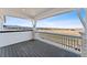 Balcony with grey deck and white railings overlooks a stunning neighborhood and mountain view at 8950 Whiteclover St, Littleton, CO 80125
