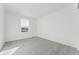 Bright bedroom with gray carpet and a large window providing natural light at 8950 Whiteclover St, Littleton, CO 80125