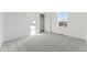 A well-lit bedroom featuring neutral carpet, closet, and large window at 8950 Whiteclover St, Littleton, CO 80125