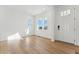 Inviting entryway features light wood floors, large windows, and a bright white front door at 8950 Whiteclover St, Littleton, CO 80125