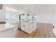 Bright and airy kitchen featuring a spacious island that opens to the dining and living areas at 8950 Whiteclover St, Littleton, CO 80125