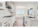 A sleek kitchen with a gas range, stainless steel appliances, and a view into the adjacent dining area at 8950 Whiteclover St, Littleton, CO 80125