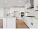 Contemporary kitchen boasting an island, modern stainless steel appliances, and abundant cabinet storage at 8950 Whiteclover St, Littleton, CO 80125