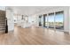 Bright, open-concept living space with hardwood floors and sliding doors to a covered balcony at 8950 Whiteclover St, Littleton, CO 80125