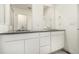 Bathroom featuring double sinks with modern fixtures, white cabinetry, and a sleek, spacious design, ideal for comfortable living at 16432 Snowbourn Dr, Parker, CO 80134