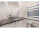 Modern bathroom showcasing a single sink with neutral finishes, white cabinetry, and a shower with a curtain at 16432 Snowbourn Dr, Parker, CO 80134