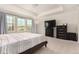Bright bedroom featuring neutral walls, plush carpet, a ceiling fan, and abundant natural light from large windows at 16432 Snowbourn Dr, Parker, CO 80134