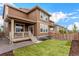 Exterior view of a two-story home, showcasing a fenced yard and porch at 16432 Snowbourn Dr, Parker, CO 80134