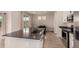 Stylish kitchen featuring stainless steel appliances, a center island, and a dining area at 16432 Snowbourn Dr, Parker, CO 80134