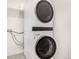 Modern laundry area showcasing stacked washer and dryer units in a clean and well-organized space at 16432 Snowbourn Dr, Parker, CO 80134