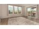Bright living room with a sliding door, a neutral rug, and laminate wood flooring at 16432 Snowbourn Dr, Parker, CO 80134