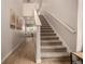 Bright interior featuring a carpeted staircase and light wood flooring leading to the upper level at 16432 Snowbourn Dr, Parker, CO 80134