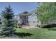 Expansive backyard with a stone patio and lush landscaping, perfect for outdoor living at 22921 E Euclid Cir, Aurora, CO 80016