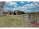Large backyard with grass, young trees, and other plantings on a sunny day, providing a serene and open space at 22921 E Euclid Cir, Aurora, CO 80016