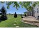 Expansive stone patio with outdoor seating and views of the green lawn and open landscape at 22921 E Euclid Cir, Aurora, CO 80016