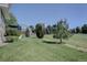 Lush backyard featuring a well-maintained lawn and mature trees, a serene outdoor space at 22921 E Euclid Cir, Aurora, CO 80016