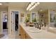 Bright bathroom featuring a double vanity, walk-in closet, decorative lighting, and a glass-enclosed shower at 22921 E Euclid Cir, Aurora, CO 80016