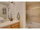 Bright bathroom featuring a single vanity, decorative mirror, and a glass-enclosed shower at 22921 E Euclid Cir, Aurora, CO 80016