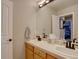 Bright bathroom featuring a double vanity, decorative mirror, and a neutral color palette at 22921 E Euclid Cir, Aurora, CO 80016