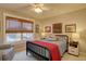 Bedroom featuring a bed, a ceiling fan, a large window, and decorative art at 22921 E Euclid Cir, Aurora, CO 80016
