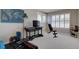 Versatile bonus room, with workout equipment, a desk, and plenty of natural light from shuttered windows at 22921 E Euclid Cir, Aurora, CO 80016