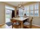 Bright eat-in breakfast nook with lots of light, wood table, and exterior access to the outdoors at 22921 E Euclid Cir, Aurora, CO 80016