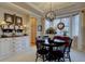 Elegant dining room featuring a round table, modern chandelier, and decorative accents at 22921 E Euclid Cir, Aurora, CO 80016