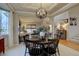 Bright dining area with a round table, stylish light fixture, and adjoining living spaces at 22921 E Euclid Cir, Aurora, CO 80016