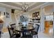 Elegant dining area with round table, staircase view, and decorative elements at 22921 E Euclid Cir, Aurora, CO 80016