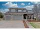 Charming two-story home featuring a three-car garage and a landscaped front yard under a cloudy sky at 22921 E Euclid Cir, Aurora, CO 80016