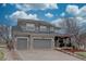 Stately two-story home featuring a three-car garage, stone accents, and a well-manicured front yard for curb appeal at 22921 E Euclid Cir, Aurora, CO 80016