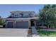 Charming two-story home featuring a three-car garage, well-kept lawn, and attractive landscaping at 22921 E Euclid Cir, Aurora, CO 80016