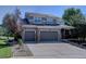 Beautiful two-story home boasts a three-car garage, gray siding, and meticulously maintained landscaping at 22921 E Euclid Cir, Aurora, CO 80016