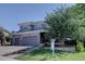 Two story home features a three car garage, stone accents, and well-manicured lawn at 22921 E Euclid Cir, Aurora, CO 80016