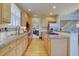 Bright kitchen featuring wooden floors, cabinets, granite counters, stainless appliances, and eat-in bar at 22921 E Euclid Cir, Aurora, CO 80016