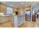 Open concept kitchen featuring stainless appliances, granite counters, light wood cabinets and floors at 22921 E Euclid Cir, Aurora, CO 80016