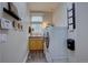Convenient laundry room featuring modern washer and dryer, storage, and a utility sink at 22921 E Euclid Cir, Aurora, CO 80016