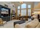 Bright living room with fireplace, high ceilings, large windows, and open floor plan at 22921 E Euclid Cir, Aurora, CO 80016