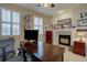 Office with large windows, fireplace, and decor at 22921 E Euclid Cir, Aurora, CO 80016