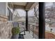 Covered porch featuring stone facade and black railings at 22921 E Euclid Cir, Aurora, CO 80016