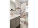 Well-lit bathroom featuring a stylish vanity, floral shower curtain, and tiled walls at 2665 S Pennsylvania St, Denver, CO 80210