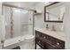 Modern bathroom featuring a glass-enclosed shower and updated vanity at 2665 S Pennsylvania St, Denver, CO 80210