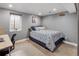 Comfortable bedroom with a decorative bed and natural light from the window at 2665 S Pennsylvania St, Denver, CO 80210